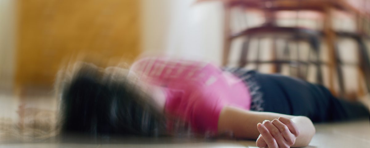 Woman lying on the floor out of focus image