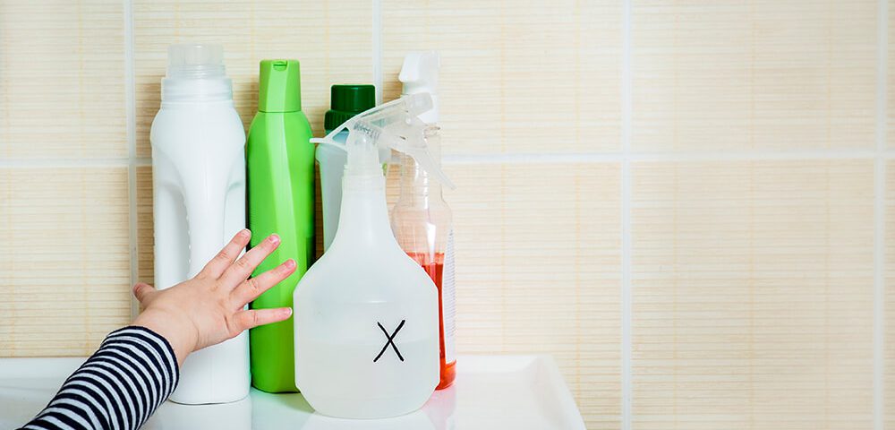 Child reaching for cleaning supplies