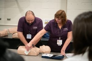 UPMC prehospital staff training the Pittsburgh Penguins staff how to apply an AED.