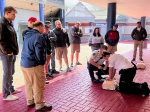 Williamsport Crosscutter staff watch how an AED is used during a Minutes Matter training.