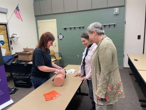 Michele Albaugh demonstrates how to control bleeding during a Minutes Matter open forum training session at LindenPointe in Hermitage.
