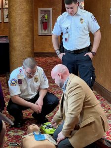 Williamsport local leaders and federal and state elected officials learn how to use an AED.